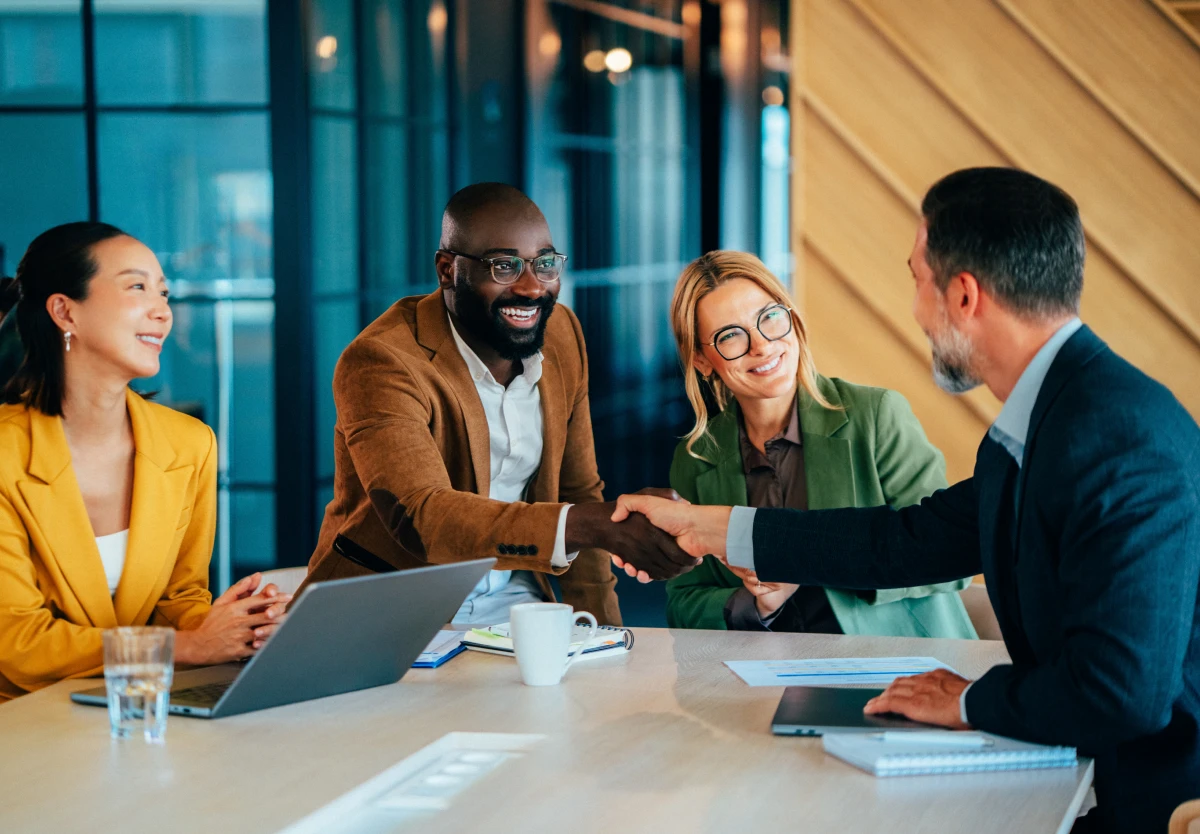 Business meeting handshake at conference table